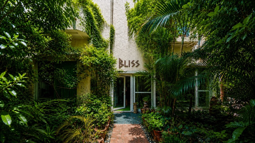 The lush green garden entrance of Dr. Bali's Bliss holistic health centre in Delhi